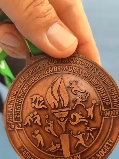 A duplicate image of the bronze medal, highlighting the achievement of our deaf tennis athlete.