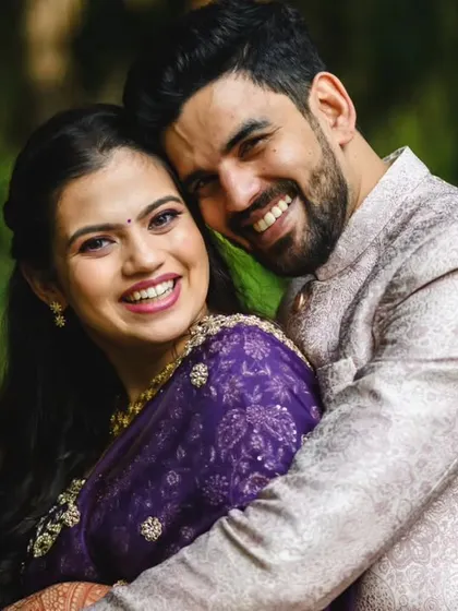 A tighter crop of that happy hug. The vibrant purple of Sanika's saree and their joyful expressions make this a standout engagement photo.