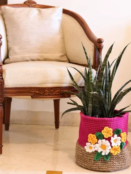 My Festive Spirit Catch-All Basket, shown here as a beautiful planter. The combination of natural jute and a band of bright pink with flowers makes it a joyful addition to any room.
