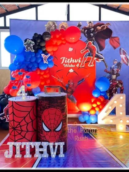 Jithvi's 4th birthday was a web-slinging success with this Spider-Man theme. The decor features a city skyline backdrop, Spider-Man cutouts, and plinths decorated with web patterns and the iconic spider logo.