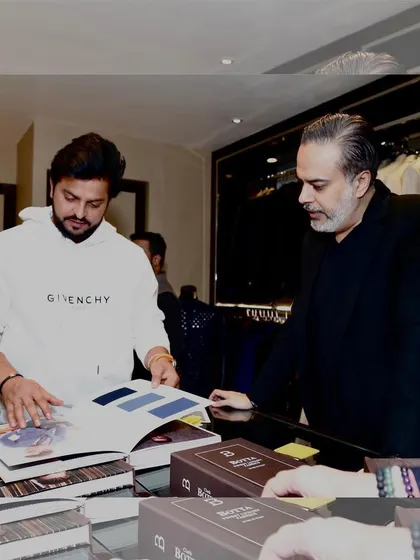 It was a pleasure to host cricketer Suresh Raina at our store. Here, we are looking through fabric catalogs to find the perfect materials for his bespoke garments, a process I enjoy with every client.
