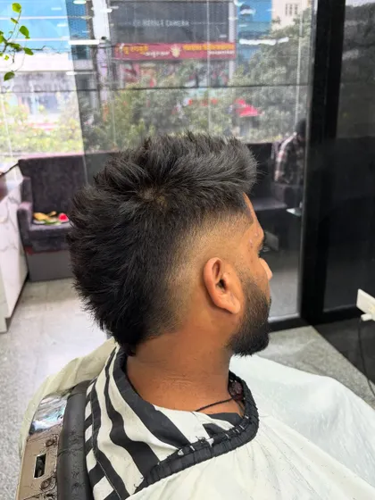 The back view of a burst fade, showing the unique shape and how it blends into the longer hair on top.