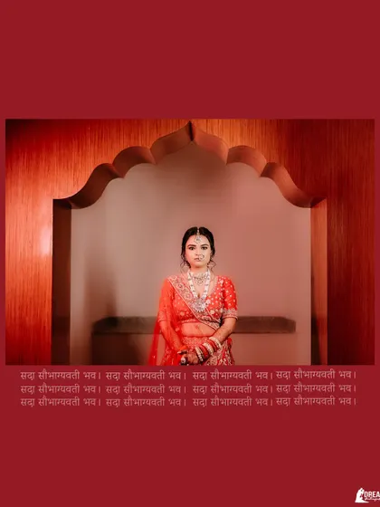 A portrait of bride Anvita in her red lehenga, framed perfectly within an arched doorway, creating a regal and traditional look.