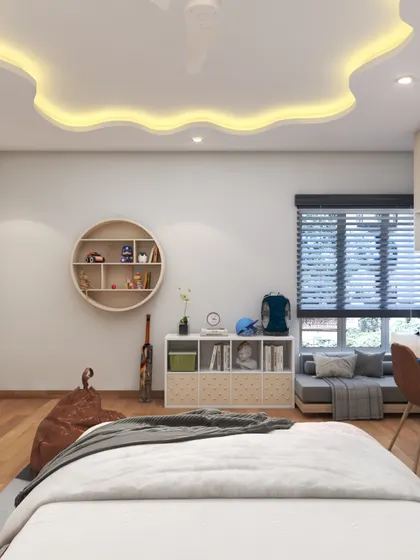 A dreamy and whimsical bedroom design for a child. The cloud-shaped false ceiling with backlighting is a magical touch, and the circular shelf is perfect for displaying toys.