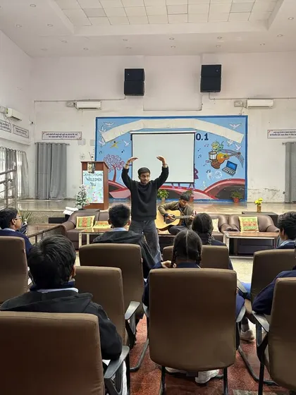 In a school library, a fellow leads a session on creative expression. We adapt our programs to different school environments, turning any space into a stage for learning.