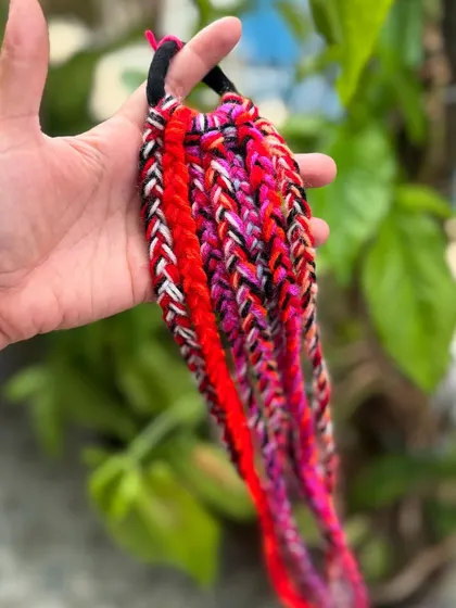 Another color option for our hair braids, this time with shades of pink and red.