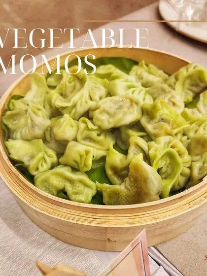 These delicate vegetable momos are steamed to perfection and served in a traditional bamboo basket. They are a light and flavorful starter for any event.