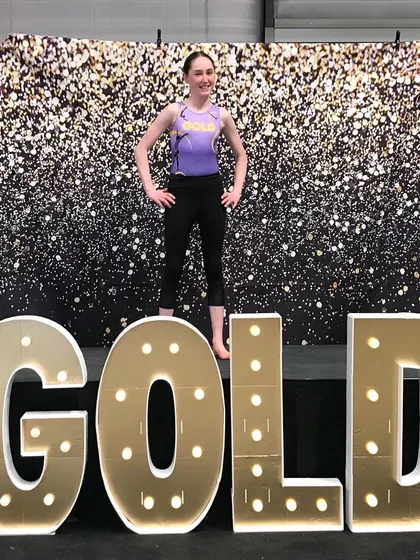 A confident pose from one of our Xcel Gold gymnasts at regionals.