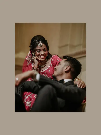 A candid and playful moment of the couple sharing a laugh during their reception portraits.