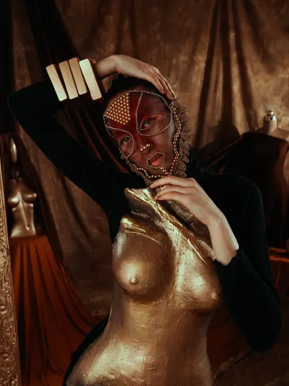 Another look from the golden breastplate series, this time interacting with a golden mannequin, blurring the lines between art and the human form.