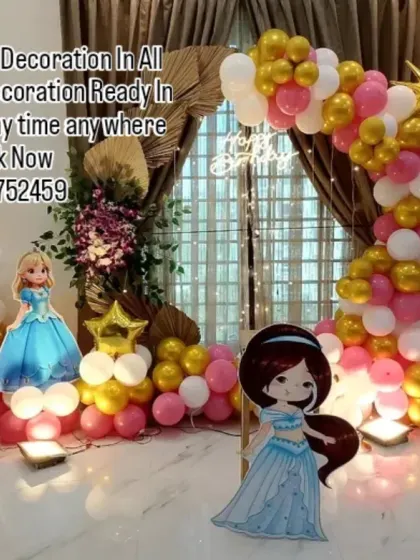 A grand princess theme featuring cutouts of Elsa, Jasmine, and other beloved characters. The pink, gold, and white balloon arch is complemented by a large light-up number '3' for a magical celebration.