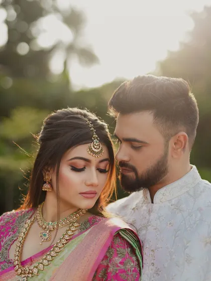 A romantic portrait of the couple. The bride's soft glam makeup looks beautiful in the warm, diffused light.