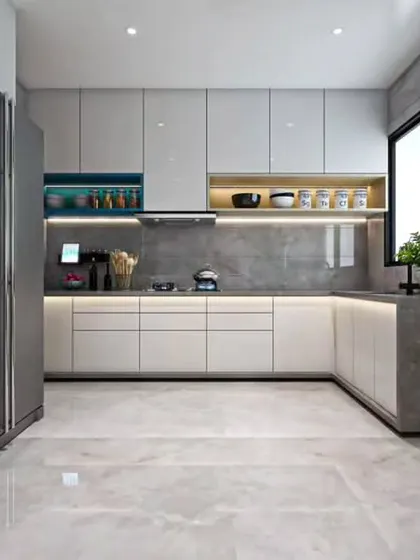 This minimalist U-shaped kitchen features handleless white cabinets and a grey stone-effect countertop that extends up one side. Open shelving in a contrasting blue adds a functional pop of color.