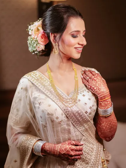 A serene portrait of the bride, showcasing her beautiful makeup, hairstyle, and the intricate details of her henna.
