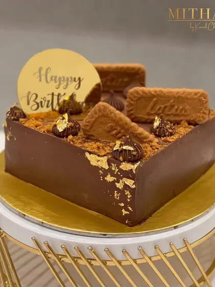 My Lotus Biscoff cake in a heart shape, perfect for a birthday. The rich chocolate frosting is topped with Biscoff cookies and crumbs, and finished with delicate gold leaf.