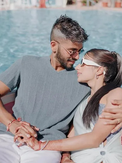 An intimate moment between the bride and groom during their relaxing pool party at Khimsar Fort.