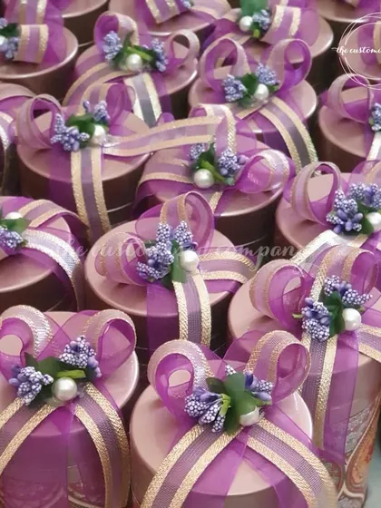 Baraat Swagat favors that make a statement. These beautifully decorated gift boxes in vibrant purple are perfect for welcoming your guests with style and warmth.