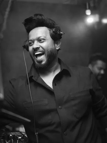 A candid laugh behind the decks. This is what pure happiness looks like.