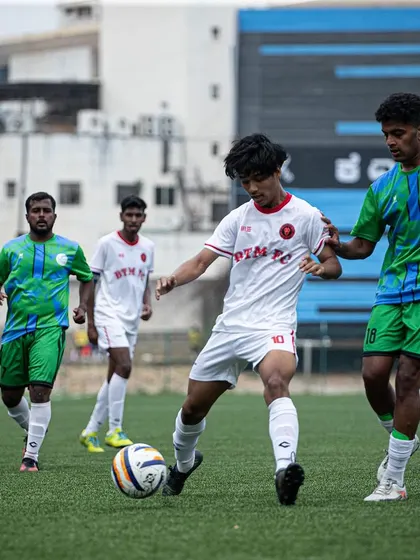 A player dribbles forward under pressure, looking to create an attacking opportunity. Our style encourages confident, forward-thinking football.