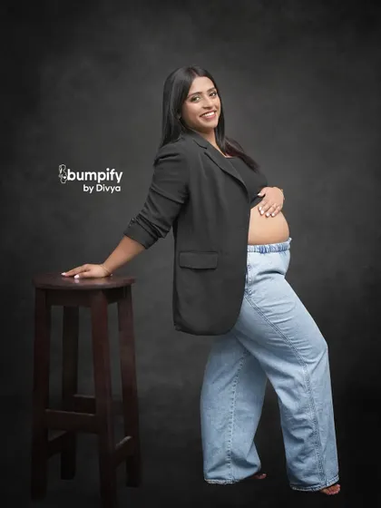A confident and modern maternity portrait. The mom-to-be's choice of a blazer and jeans shows that you can bring your own personal style to the shoot.
