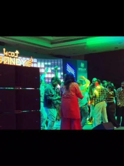 The party in full swing at the Bitsilica anniversary, with green lighting and a happy crowd.