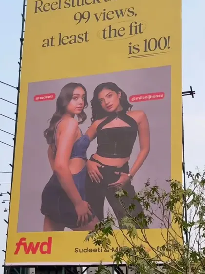 The corresponding billboard for the denim look, showcasing how the subtle makeup enhances the models' features without distracting from the fashion.
