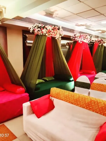 Planning a small Mehendi or Haldi event? This setup at Acres Club shows how we can transform a banquet hall with colorful cabana-style seating for an intimate and festive gathering.