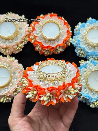 These floral T-light holders in bright orange, peach, and blue are perfect for adding a pop of color to your decor.