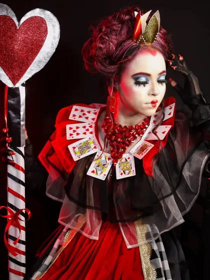 A regal and imposing Queen of Hearts look, inspired by Alice in Wonderland. This showcases character makeup and costume integration.