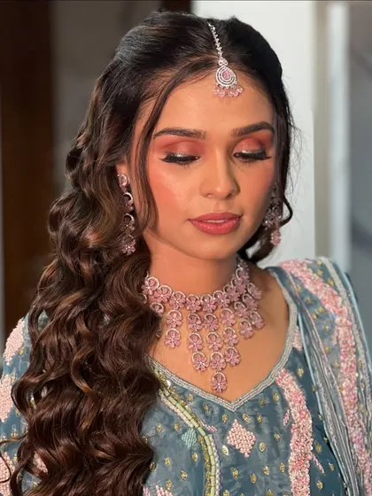 A close-up of the soft, peachy-pink eyeshadow and flawless skin.