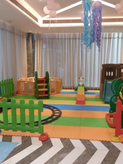 Another view of the ocean-themed indoor setup, this time showing the circular ball pit and climbing structure. I can work with your party's theme to create a cohesive and magical play environment.