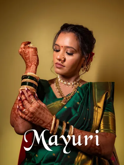 An elegant portrait of the bride, Mayuri, showcasing her intricate jewelry and beautiful green saree.
