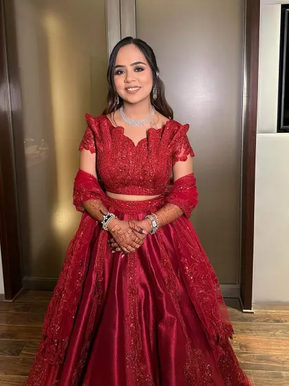 A closer look at this sangeet slay. The makeup is clean and defined, with a focus on the dramatic eyes and flawless skin, proving that red is always a classic choice.