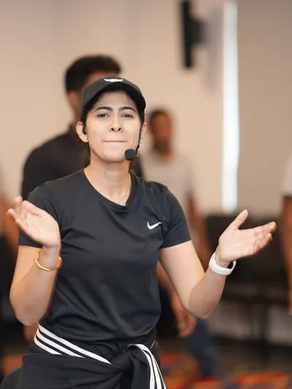 Here, I'm breaking down a move for the group. My instructions are always clear, simple, and encouraging, so no one feels left behind, regardless of their dance experience.
