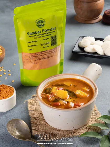 To showcase this Sambar Powder, I created a complete scene with the prepared dish and its core ingredients. This helps customers understand the product's use and the authentic flavor it can create.