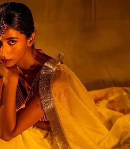 A striking close-up from the Nayantaara campaign. The makeup is clean with a focus on the eyes, enhanced by the traditional maang tikka, creating a captivating and intense portrait.