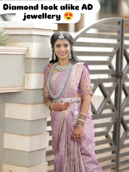 I help you achieve that perfect modern bridal look. Here, we styled a gorgeous American Diamond layered necklace set with emerald-green stones to match this bride's reception lehenga, creating a look that's both glamorous and sophisticated.