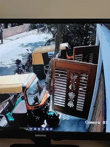 Another angle of the street, capturing vehicles and the entrance to the property.