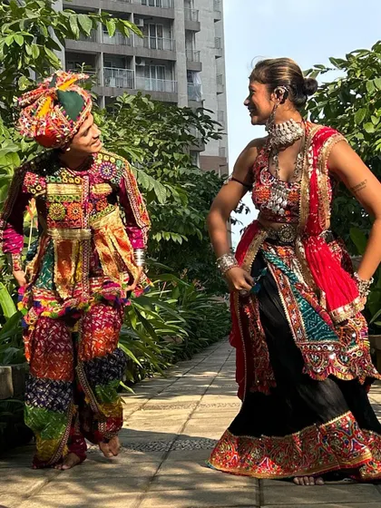 Another stunning couple's combination, this time featuring a vibrant red and black chaniya choli paired with a multi-colored men's kediyu.