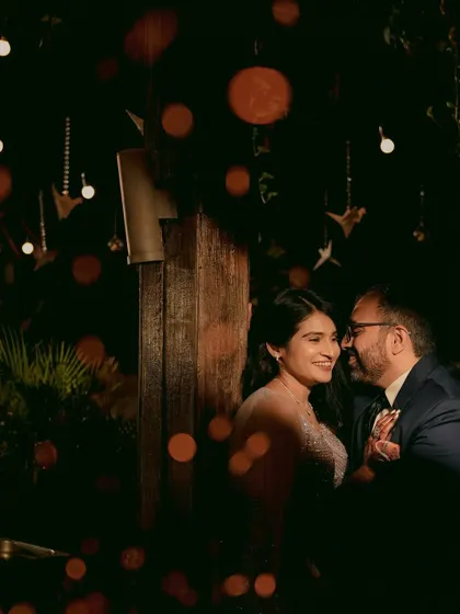 An artistic and romantic portrait of a couple at their reception, with beautiful bokeh lights creating a magical effect.