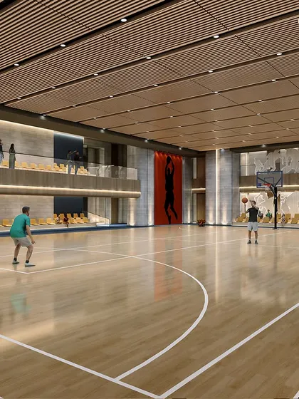The state-of-the-art basketball court at our Palais Royale sports club. This facility is designed for both intense competition and relaxed fun, featuring high-quality wooden flooring, spectator seating, and dramatic athletic-themed art.