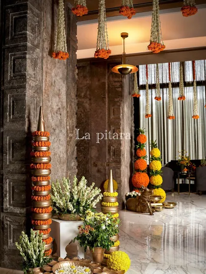 Inside the venue, the theme continued with hanging floral tassels and marigold arrangements. The warm lighting and rich textures of the venue's interior were enhanced by these traditional decorative touches.