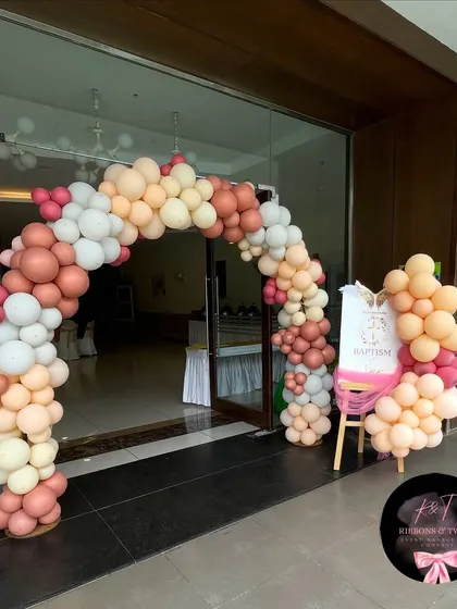 A clear, straight-on shot of the balloon arch at the entrance of the baptism party.