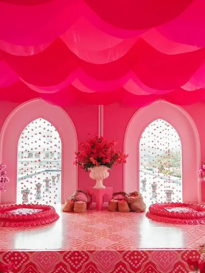 The stunning setup for a 'Gulabi Haldi' in Jaipur. The entire space was transformed with shades of pink, from the drapes to the floral arrangements, creating a unique and visually striking event.