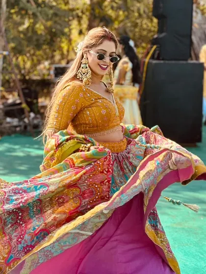 The twirl-factor on this festive lehenga is unmatched. The layers of colour and print create a beautiful spectacle as you move, ensuring you are the life of the party.