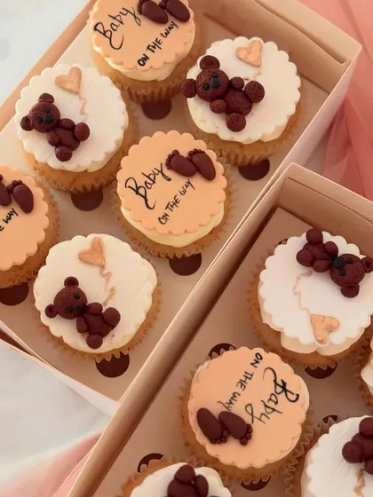 An overhead view of multiple boxes of the 'Baby on the way' teddy bear cupcakes. This image shows how I prepare larger orders for events, ensuring each box is consistently and beautifully presented.