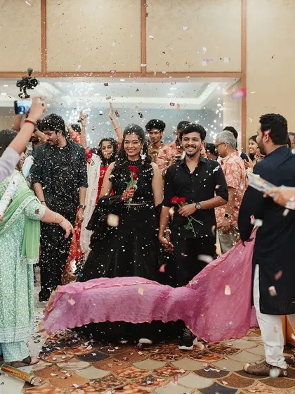 A grand entrance with friends and family creating a path with colorful dupattas and showering the couple with confetti. This is a beautiful, vibrant, and personal way to welcome the bride and groom.