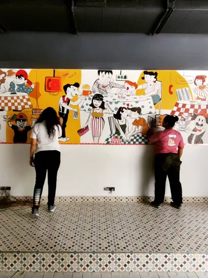 Teamwork makes the dream work. Here we are, working together to fill in the colors and details of the expansive diner mural.