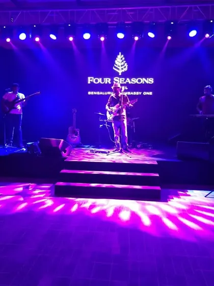 The stage is set at the Four Seasons Hotel for a corporate gathering. We are equipped to handle large-scale productions, complete with professional lighting and sound.