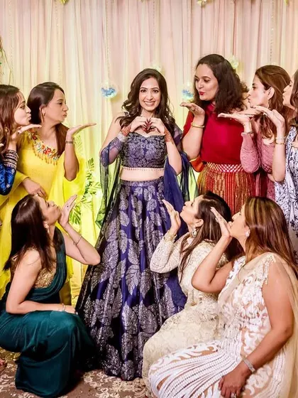 The bride and her girl gang. A fun and posed shot with all her friends blowing kisses, celebrating her big day.